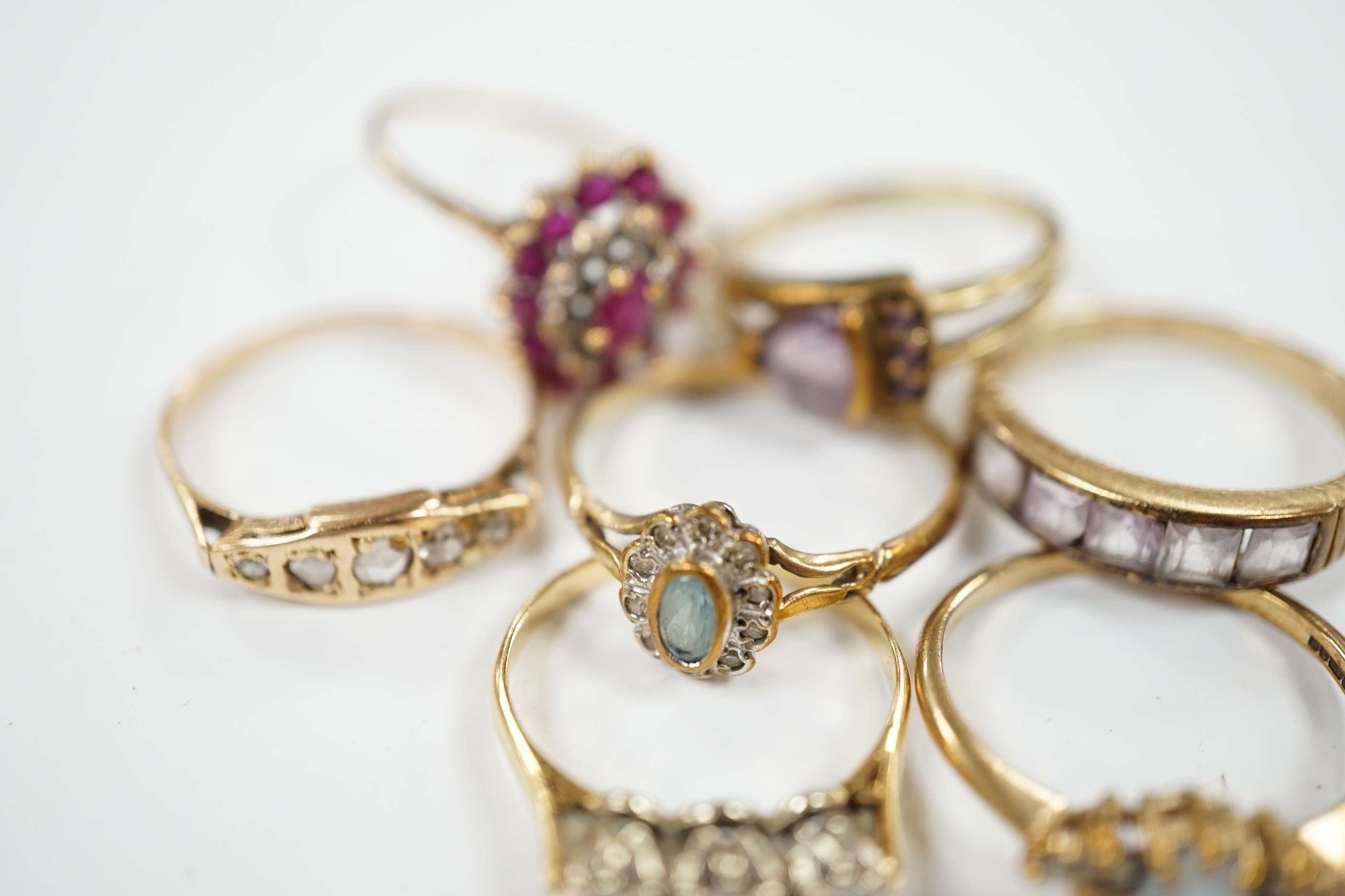 Seven assorted mainly modern 9ct gold and gem set dress rings, including three stone diamond and five stone diamond, gross weight 15.7 grams.